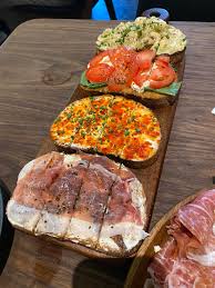 Postino Village District signature dishes Bruschetta BoardProsciutto Brie PaniniOMG Grilled Cheese
